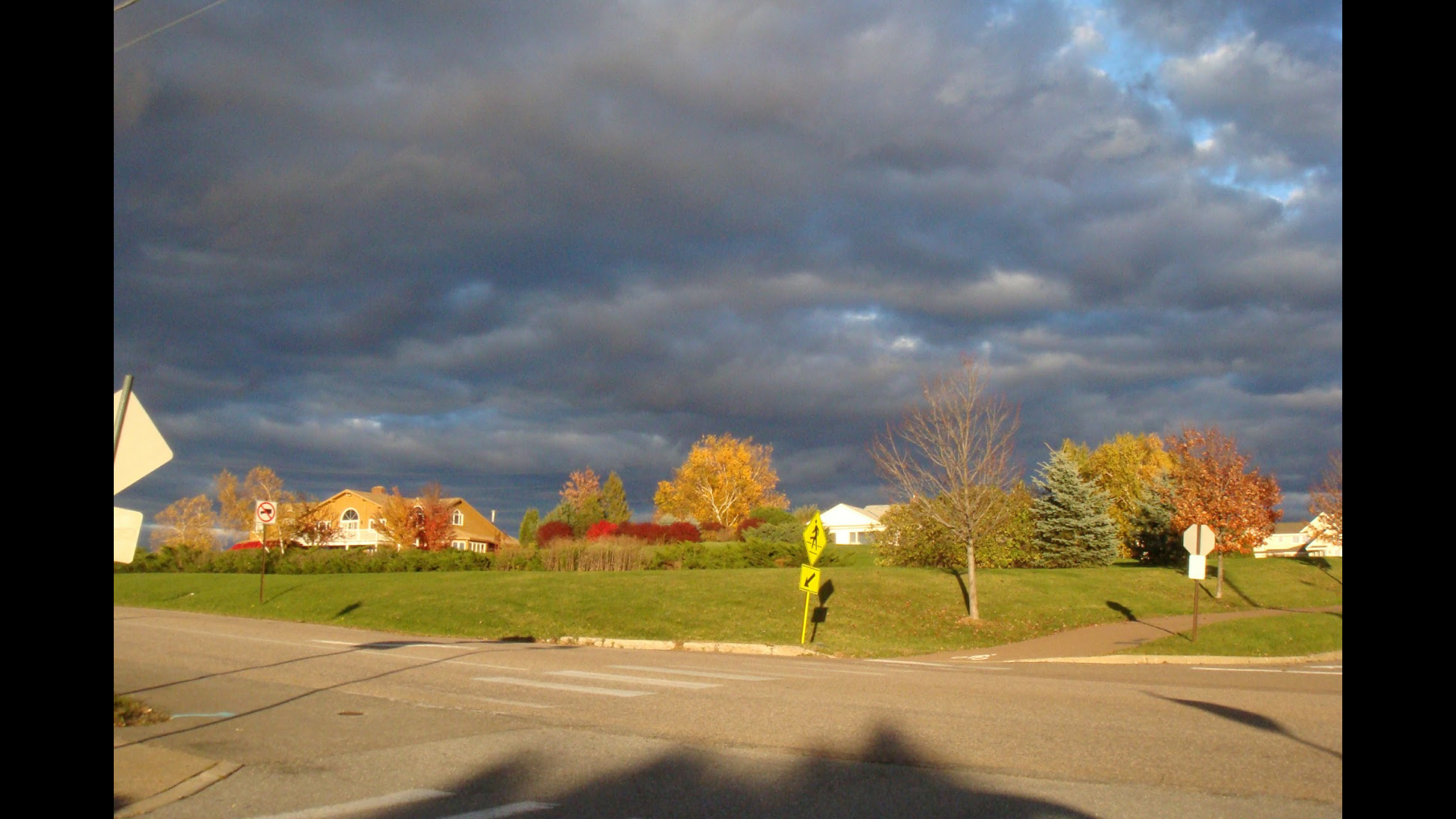 Autumn streetscape beneath dramatic clouds in Vermont
