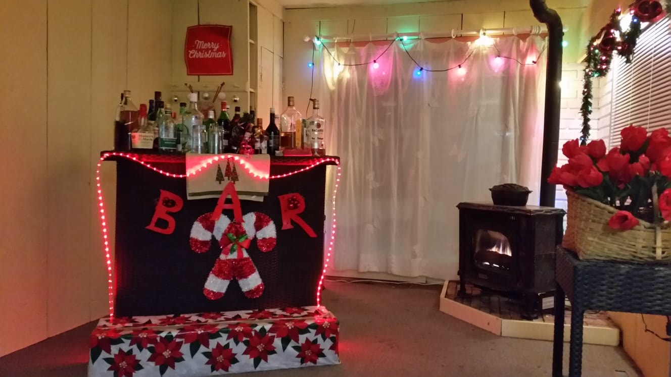 Christmas-decorated indoor bar and wood stove in Vermont